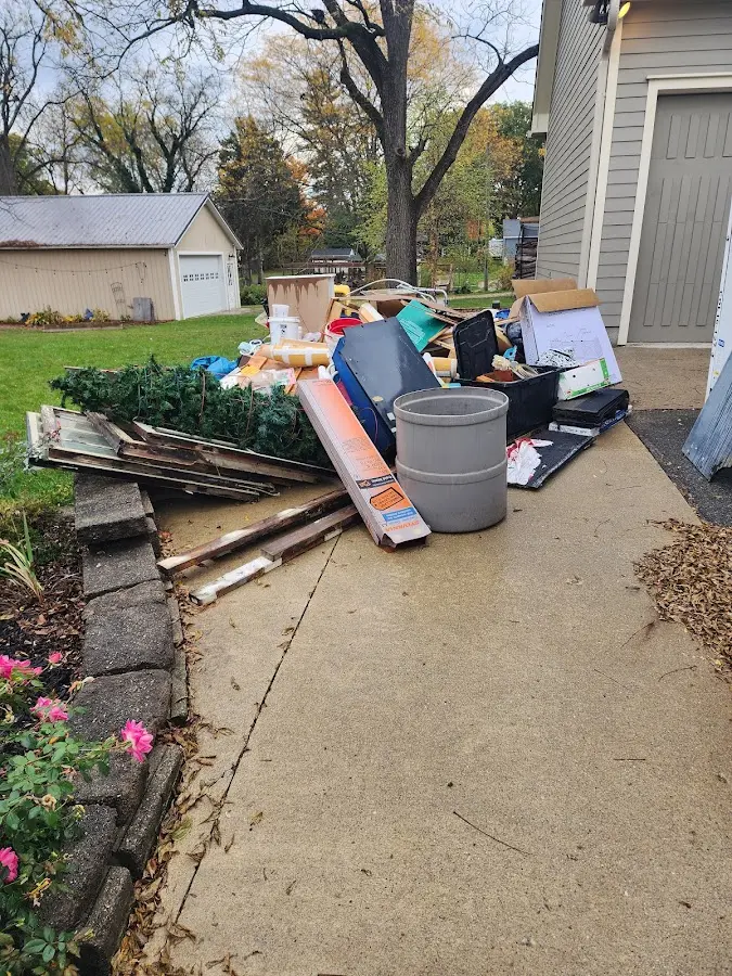 Dumpster being loaded with debris for Residential Dumpster Rental in Lansing